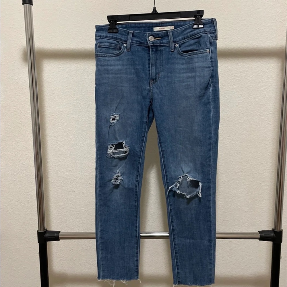 Levi’s 711 skinny jeans with holes and frayed ankles